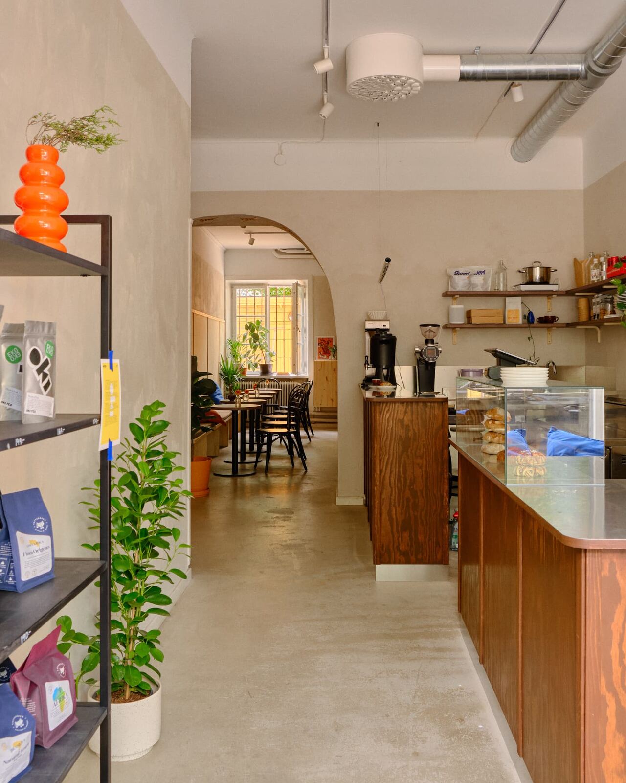 Bags of SWERL and guest roaster coffee on the shelf beside the counter at Tigre Kaffebar